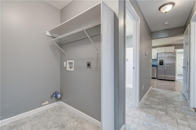 laundry room featuring electric dryer hookup and washer hookup