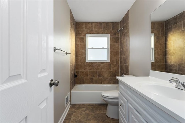 full bathroom featuring vanity, toilet, and tiled shower / bath