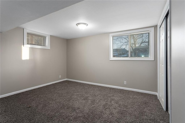 empty room featuring dark carpet