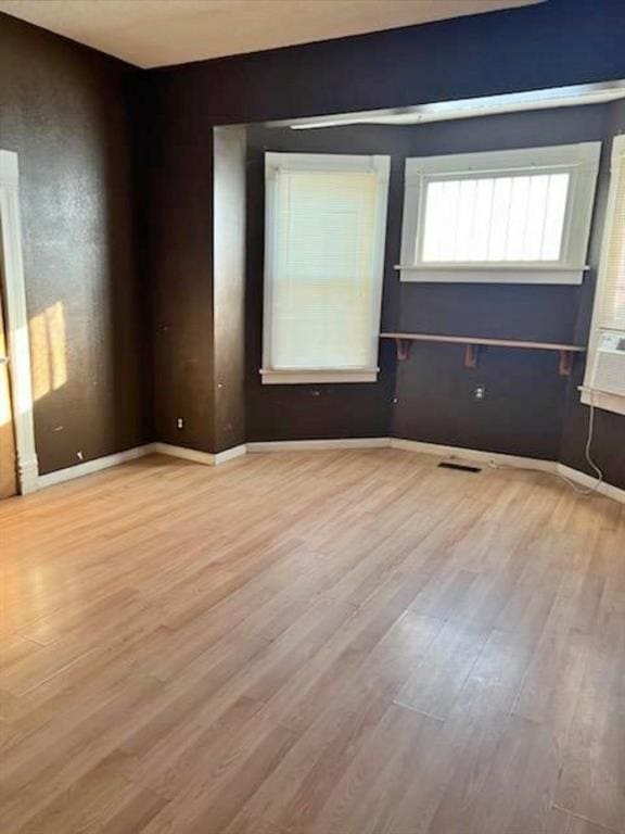 spare room with light hardwood / wood-style floors