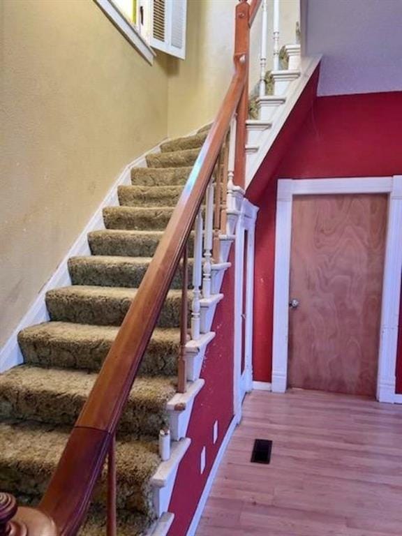 stairs with hardwood / wood-style floors