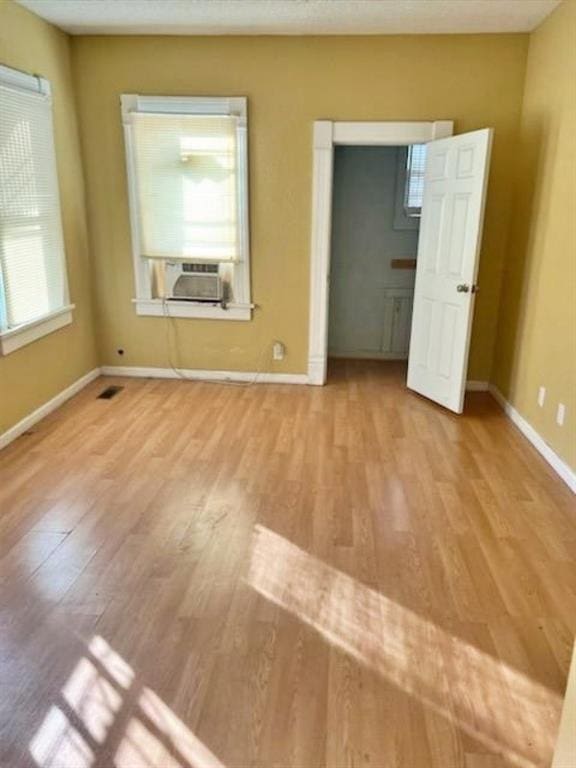 interior space featuring cooling unit and light hardwood / wood-style floors