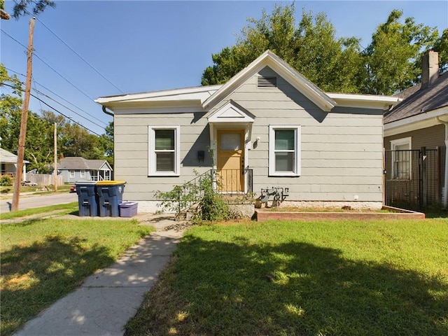 bungalow-style home featuring a front lawn