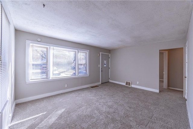 interior space with carpet floors and a textured ceiling