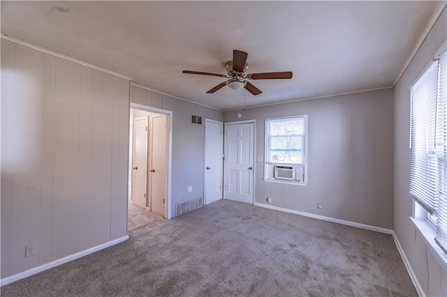 unfurnished bedroom featuring ornamental molding, light colored carpet, ceiling fan, and cooling unit