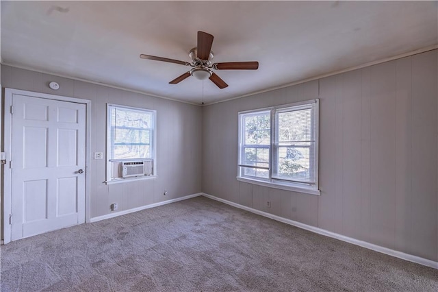 empty room with crown molding, carpet flooring, cooling unit, and ceiling fan