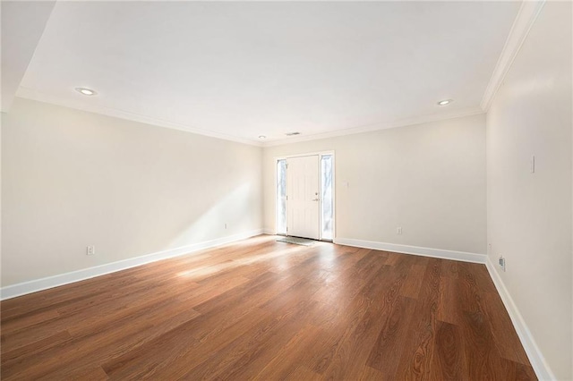 empty room featuring hardwood / wood-style flooring and crown molding