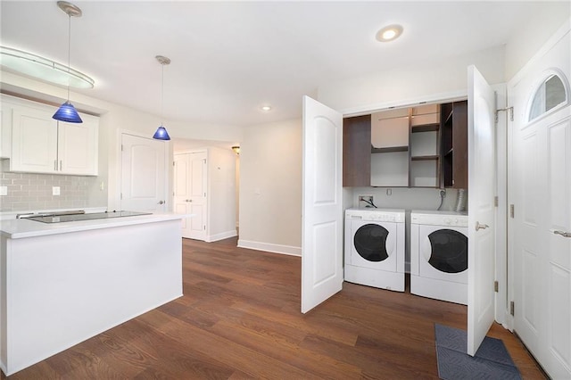 clothes washing area featuring cabinets, dark hardwood / wood-style floors, and independent washer and dryer