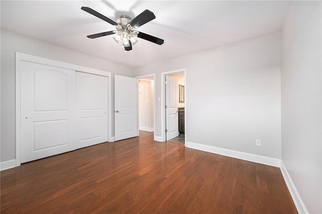 unfurnished bedroom featuring ceiling fan, connected bathroom, dark hardwood / wood-style flooring, and a closet