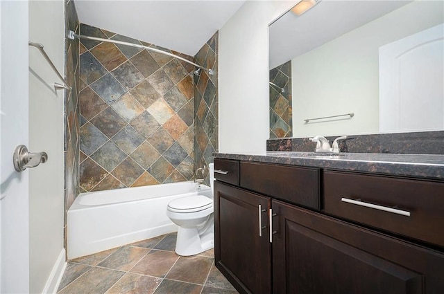 full bathroom with tiled shower / bath, vanity, and toilet