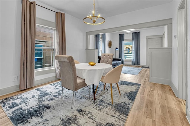 dining room featuring light hardwood / wood-style floors and a chandelier