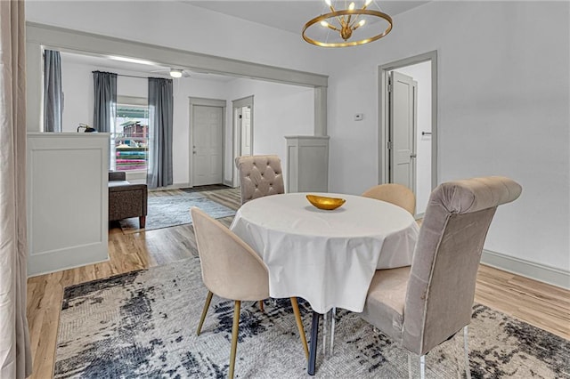 dining room featuring an inviting chandelier and light hardwood / wood-style flooring