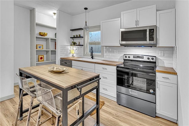 kitchen featuring appliances with stainless steel finishes and white cabinets