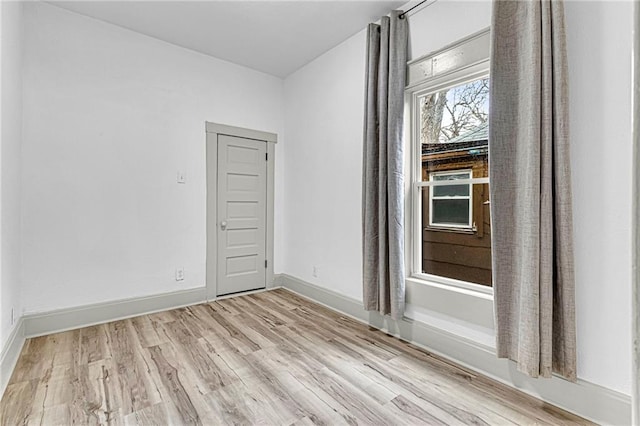 empty room with light hardwood / wood-style floors