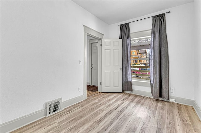 unfurnished room featuring light hardwood / wood-style flooring