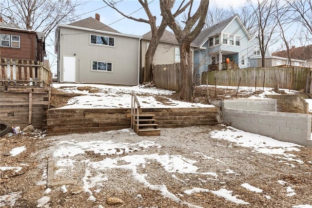 view of snow covered back of property