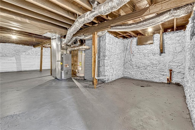 basement featuring heating unit and water heater