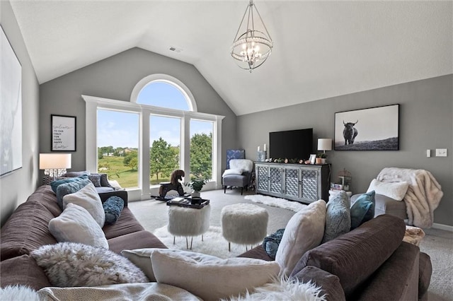 carpeted living room with an inviting chandelier, high vaulted ceiling, and a wealth of natural light