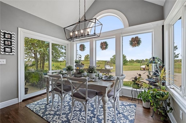 sunroom / solarium with a notable chandelier, plenty of natural light, and lofted ceiling