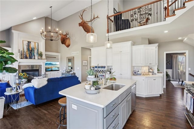 kitchen featuring dark wood-type flooring, light countertops, a sink, and visible vents