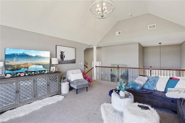 carpeted living area featuring high vaulted ceiling, visible vents, and a chandelier