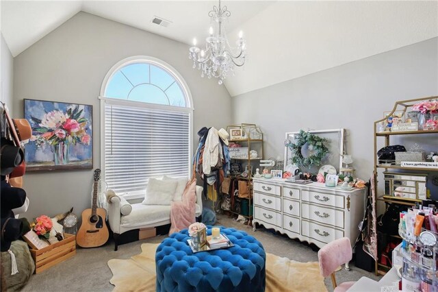 sitting room with lofted ceiling, carpet, visible vents, and a chandelier