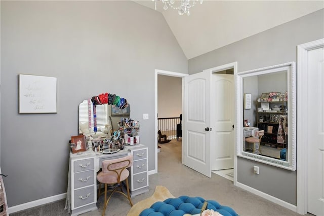 carpeted bedroom with lofted ceiling and baseboards