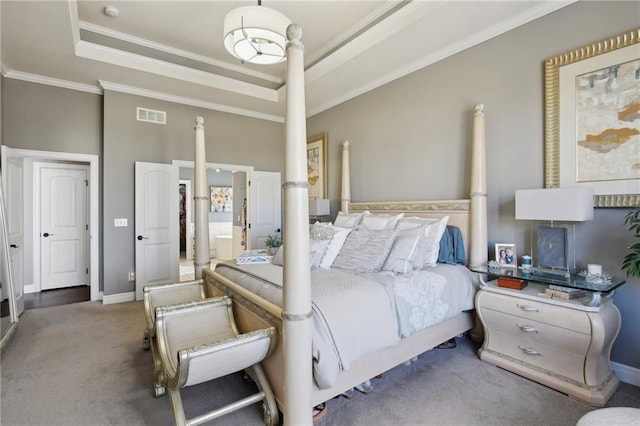 bedroom with a tray ceiling, visible vents, ornamental molding, carpet flooring, and baseboards