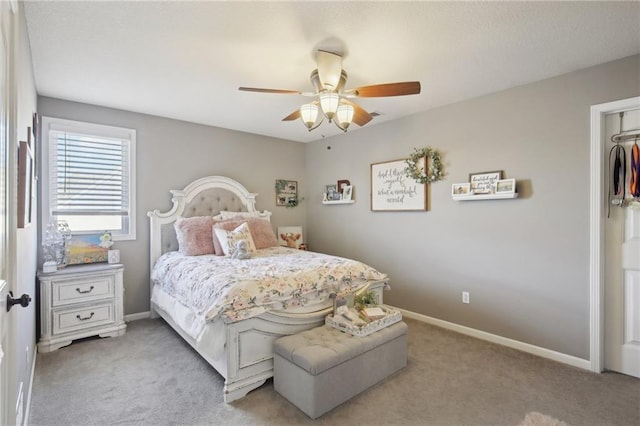 bedroom with baseboards, ceiling fan, and light colored carpet