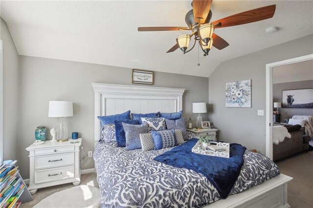 bedroom featuring baseboards, light colored carpet, lofted ceiling, ceiling fan, and a textured ceiling