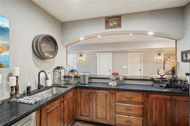 interior space with double vanity, a sink, and visible vents