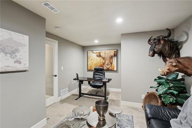 interior space with baseboards, visible vents, and light colored carpet