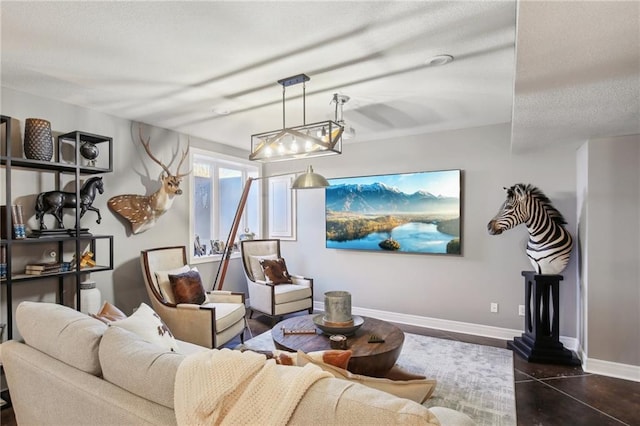 living room featuring a textured ceiling and baseboards