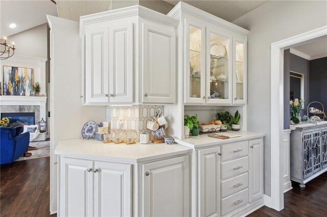 14110 Wingfoot Ct, Basehor, KS 66007 - bar featuring a fireplace, a notable chandelier, and dark wood-style flooring
