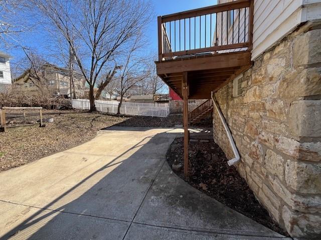 view of yard with stairs and fence