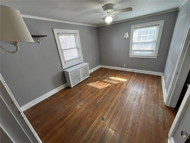 unfurnished bedroom with radiator, baseboards, dark wood-type flooring, and crown molding