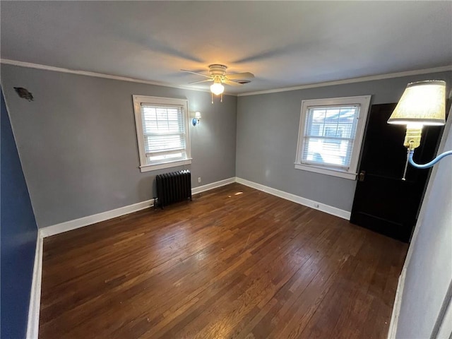 unfurnished bedroom featuring multiple windows, dark wood-type flooring, ornamental molding, and radiator heating unit