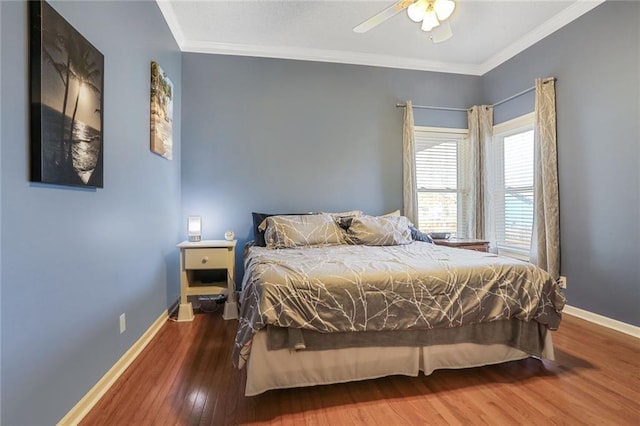 bedroom featuring baseboards, wood finished floors, and ornamental molding