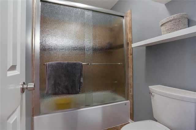 bathroom with enclosed tub / shower combo and toilet