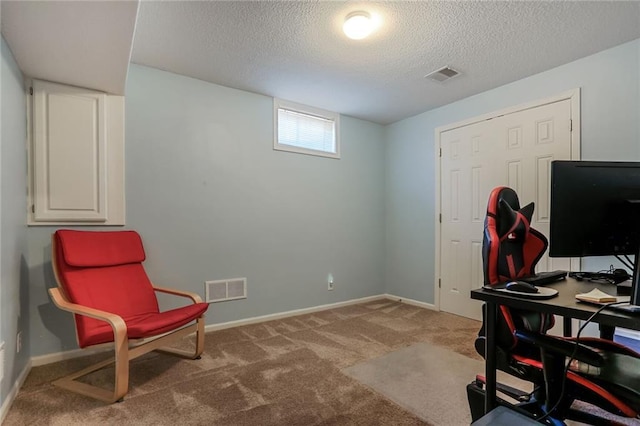 carpeted office space with a textured ceiling, visible vents, and baseboards