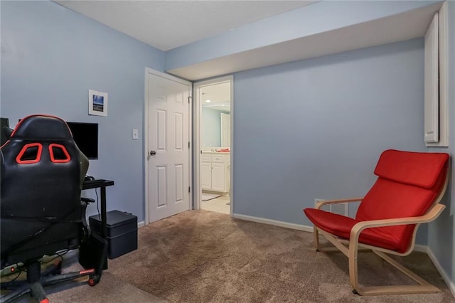 sitting room featuring baseboards and carpet flooring