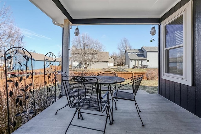 balcony featuring outdoor dining area and a patio area