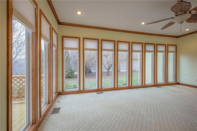 unfurnished sunroom with ceiling fan