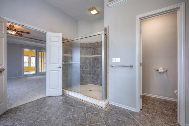 bathroom with ceiling fan, tile patterned floors, toilet, and an enclosed shower