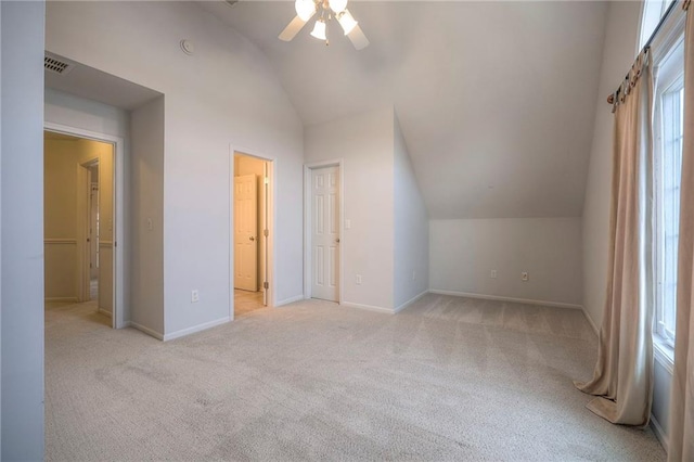 additional living space featuring lofted ceiling, light colored carpet, and ceiling fan