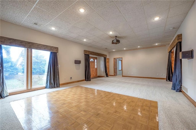 unfurnished room featuring a drop ceiling