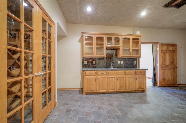 kitchen featuring backsplash and dark stone counters