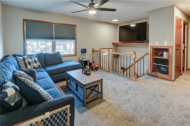 carpeted living room with ceiling fan