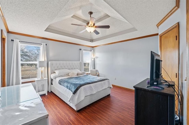 bedroom featuring a raised ceiling, dark wood-type flooring, and multiple windows