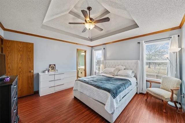 bedroom featuring ornamental molding, a textured ceiling, dark hardwood / wood-style flooring, and a tray ceiling